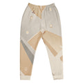 Orysha “Desert Mirage” men’s joggers featuring beige and cream geometric design, recycled fabric blend, brushed fleece interior, and slim tapered fit.