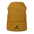 Mustard yellow knit beanie with a brand logo on a white background