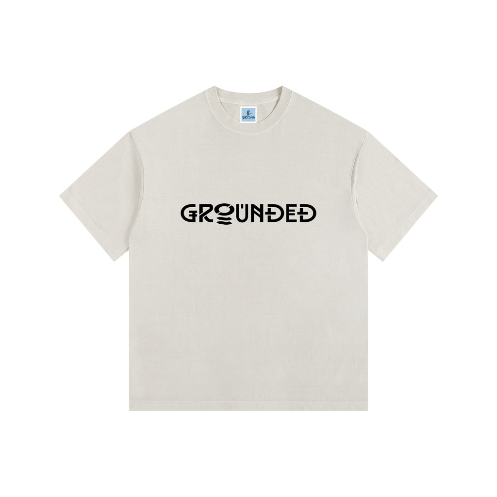 Beige t-shirt with 'GROUNDED' text on a white background