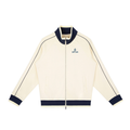 Cream-colored jacket with navy accents on a white background