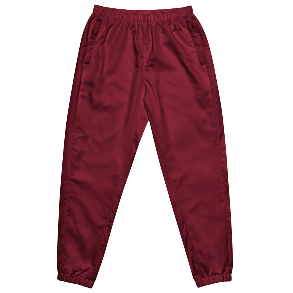 Women’s burgundy water-resistant track pants with relaxed fit and mesh lining